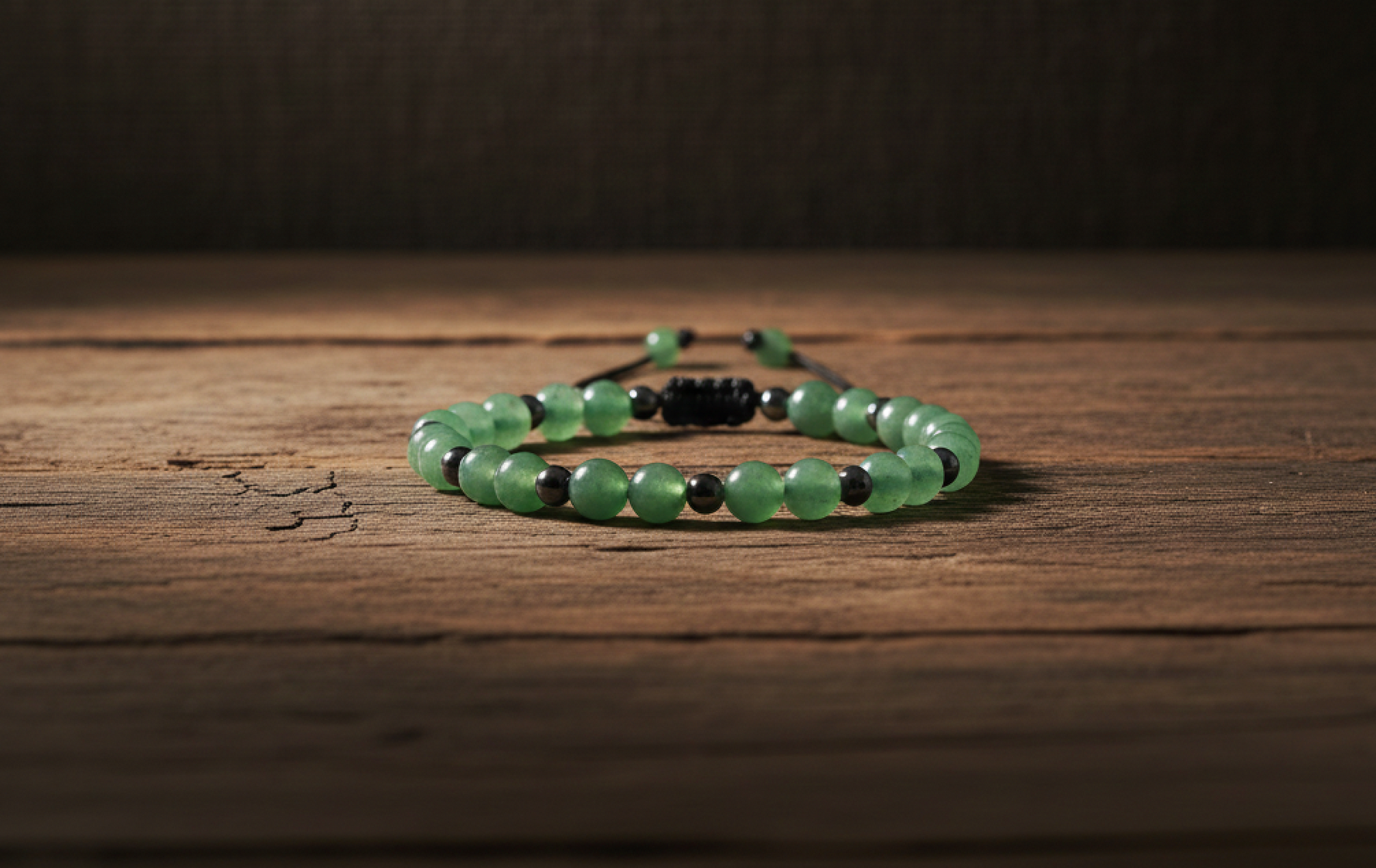 Aventurine and Hematite adjustable bracelet on a wooden surface