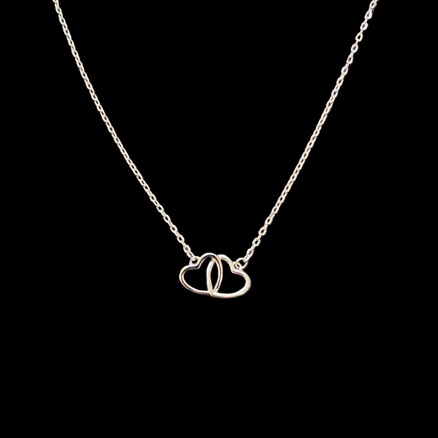 925 Sterling Silver Interlocking Hearts Necklace with two connected open heart pendants on a fine sterling silver chain.