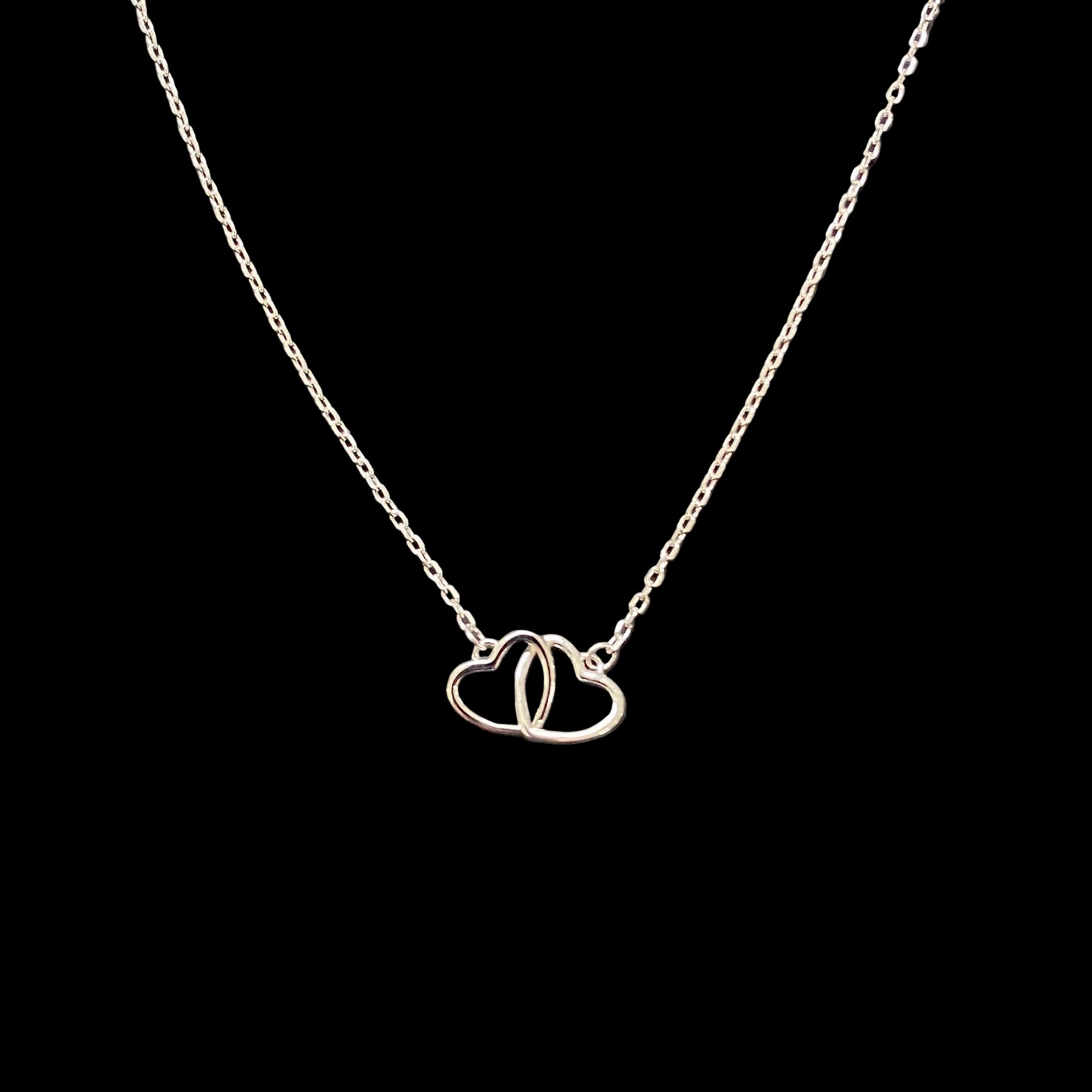 925 Sterling Silver Interlocking Hearts Necklace with two connected open heart pendants on a fine sterling silver chain.