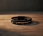 labradorite and black onyx leather bracelet on a wooden surface