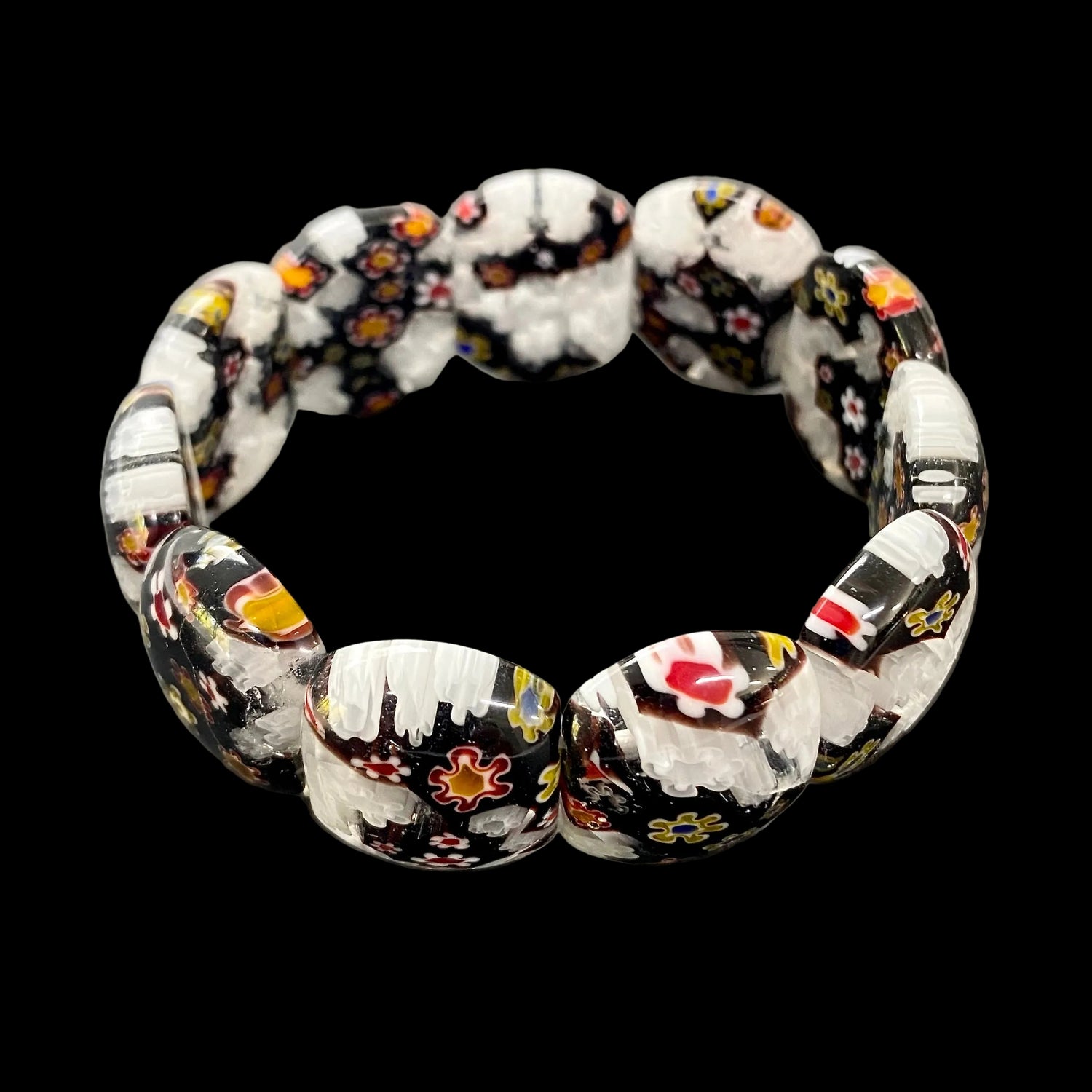 Mosaic Bracelet Verona featuring handcrafted Murano-inspired black and white glass beads with colourful Millefiori-style floral patterns and a comfortable stretch fit.