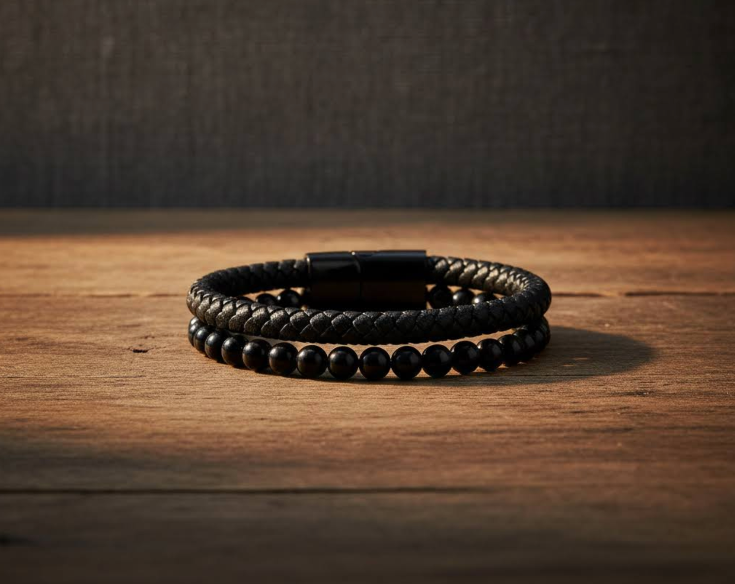 black onyx & leather bracelet on a wooden surface