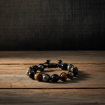 Triple Protection Bracelet - Adjustable on a wooden surface with a dark background